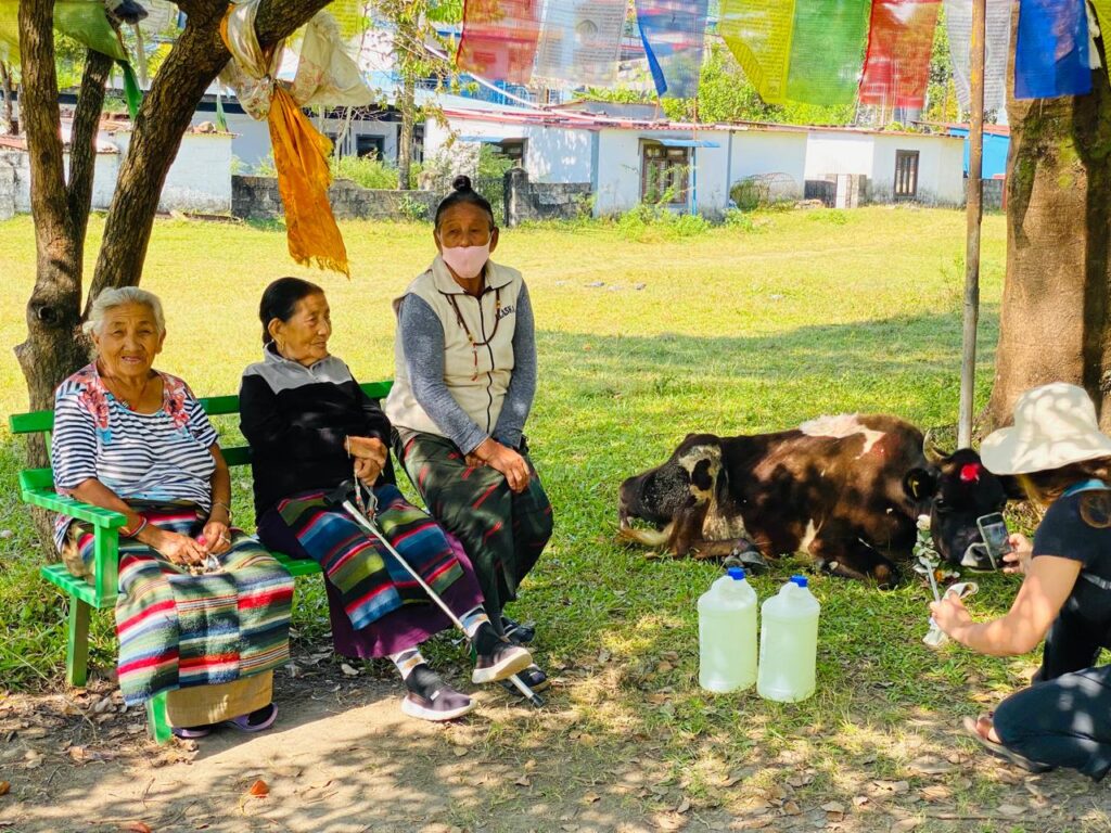 Tibetan refugee women sitting together under a tree in the settlement community