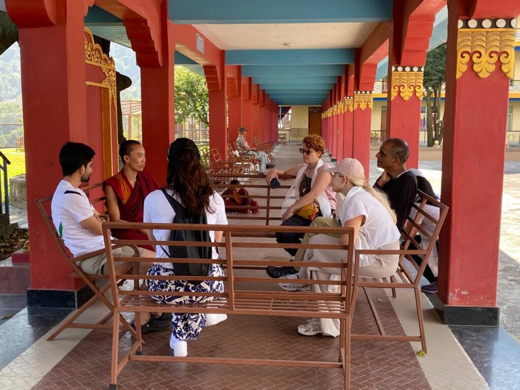 Guests learning about Tibetan culture in Nepal with a Buddhist monk