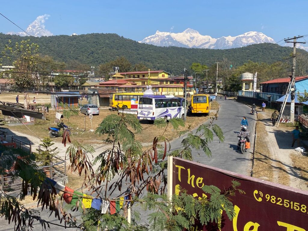 Tibetan refugee settlement in Nepal with monastery, village homes, and Himalayan views