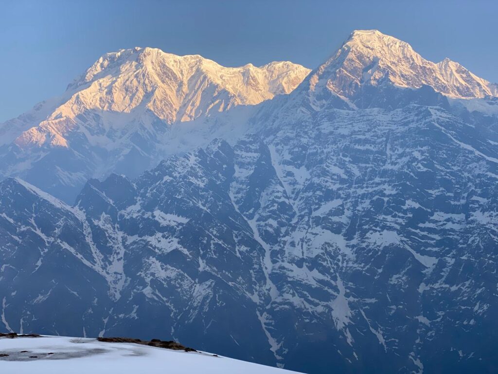 Golden sunrise light on Annapurna mountain range seen from 4500m viewpoint Nepal
