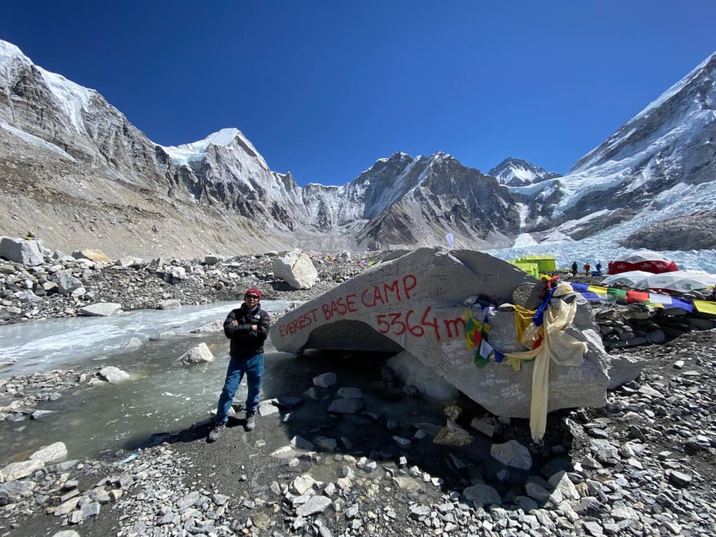 Trekker at Everest Base Camp 5364m on the EBC via Gokyo Trek with Khumbu Glacier in the background Nepal