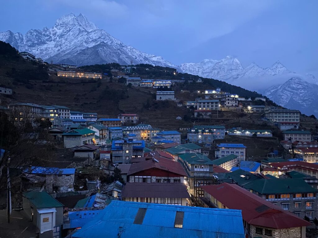 Namche Bazaar town at dusk on the EBC via Gokyo Trek with snow-capped Kongde Ri mountain in the background Nepal