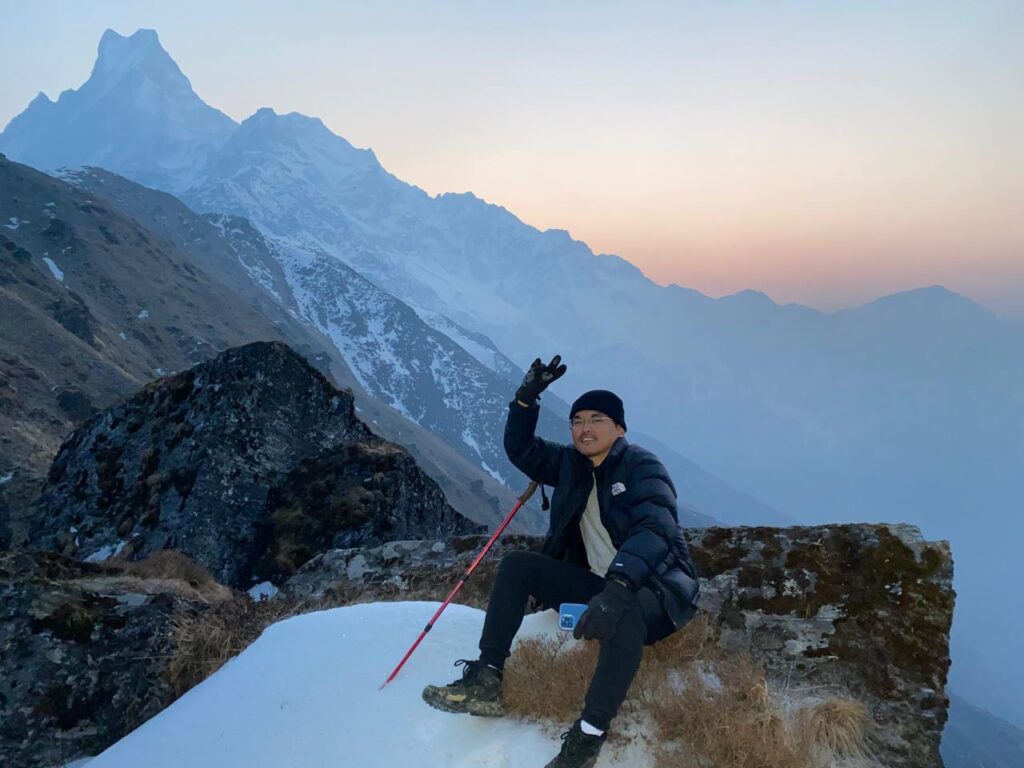 Happy trekker at the Mardi Himal Trek 5 Days viewpoint with Machhapuchhre at sunrise