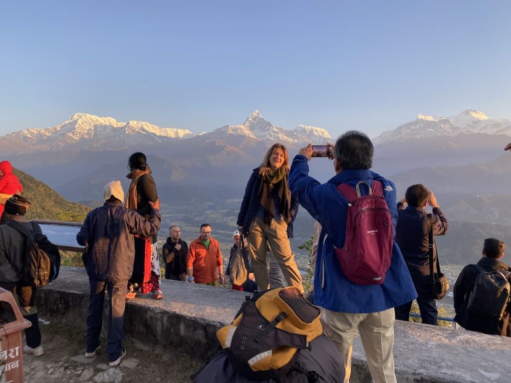 Tourists enjoying sunrise at Sarangkot viewpoint with panoramic views of Annapurna and Fishtail mountain on the Sarangkot to Naudanda day hike