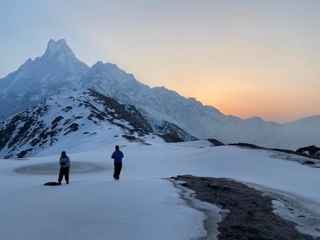 Two trekkers watching sunrise with Machhapuchhre Fishtail peak on Mardi Himal Short Trek Itinerary
