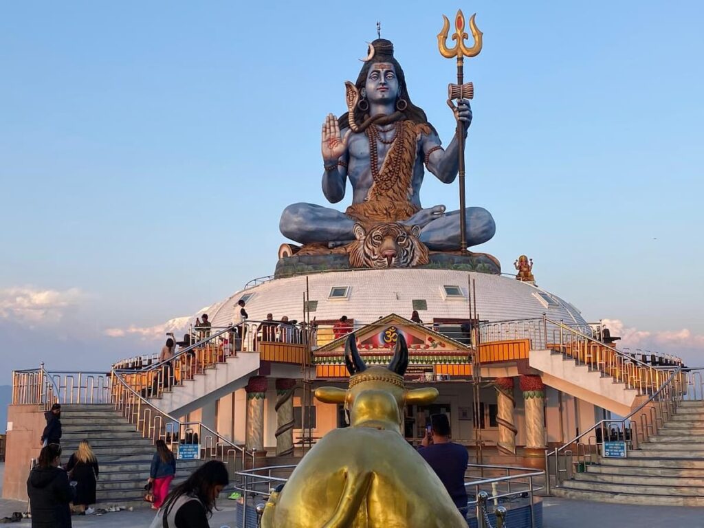 The 51-foot Lord Shiva statue at Pumdikot hill with a golden Nandi bull in the foreground