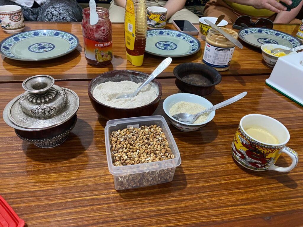 Traditional Tibetan breakfast spread with Tsampa roasted barley, butter tea and honey in Pokhara cultural tour