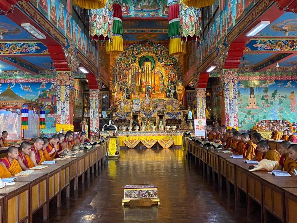 Tibetan Buddhist monks chanting morning prayers inside a monastery in Pokhara – cultural tour in Pokhara