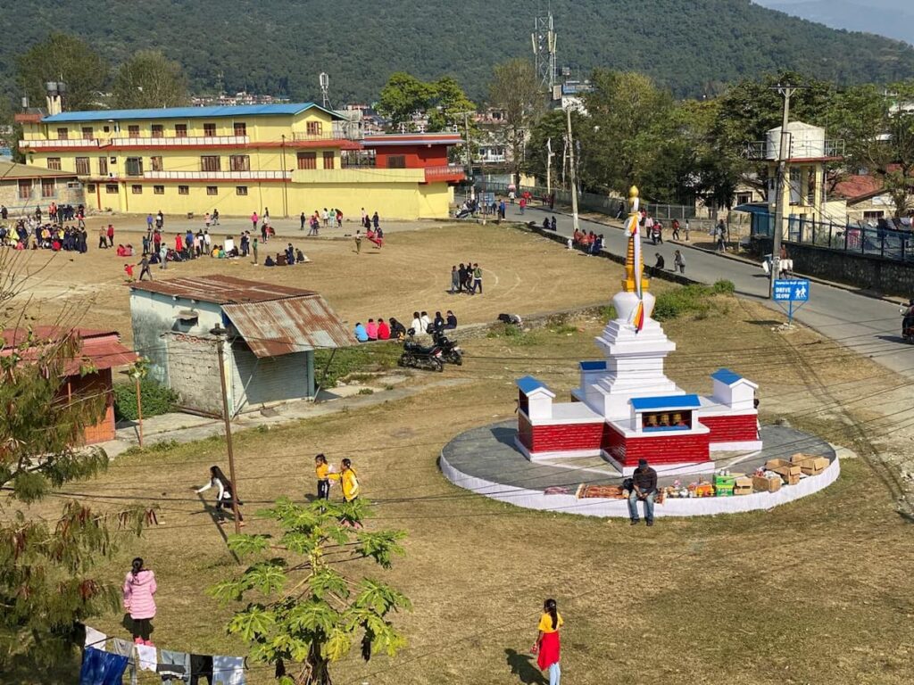 Aerial view of Tibetan refugee settlement with stupa and school building