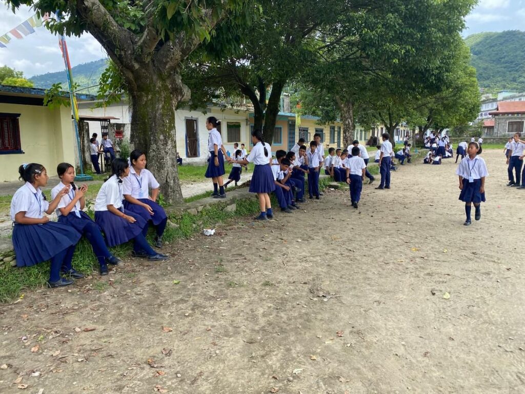 Tibetan school children in uniforms at school grounds inside the refugee settlement in Pokhara