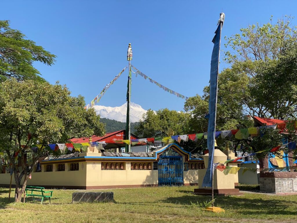 Tibetan settlement prayer flags with Annapurna mountain view — Tibetan culture tour Pokhara