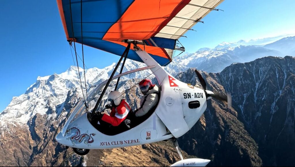 Ultralight flight Pokhara soaring above Annapurna glaciers with mountain views