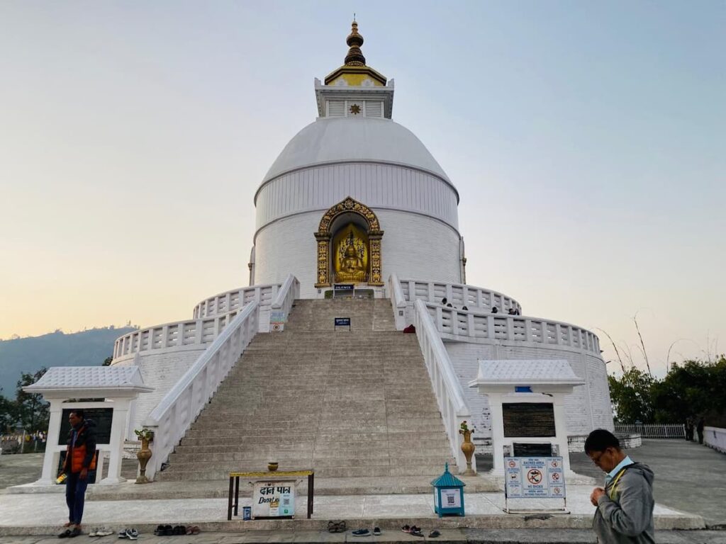 World Peace Pagoda at dusk with golden Buddha statue — one of the top attractions in Pokhara