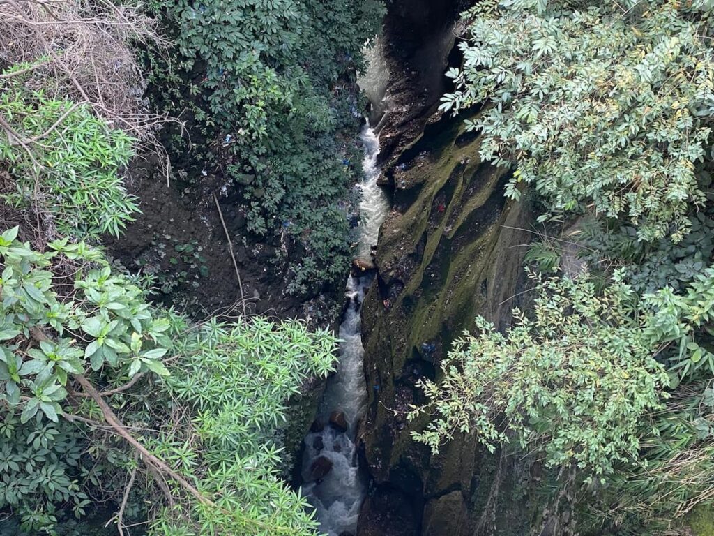 Looking down into the narrow Seti Gorge canyon during Pokhara sightseeing by car with Sarangkot sunrise