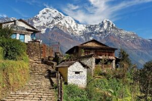 Stone steps leading through Ghandruk village with panoramic views of Annapurna South and Hiunchuli in the background