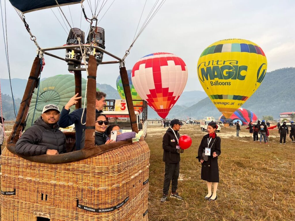 Guests smiling inside the wicker basket ahead of their balloon flight
