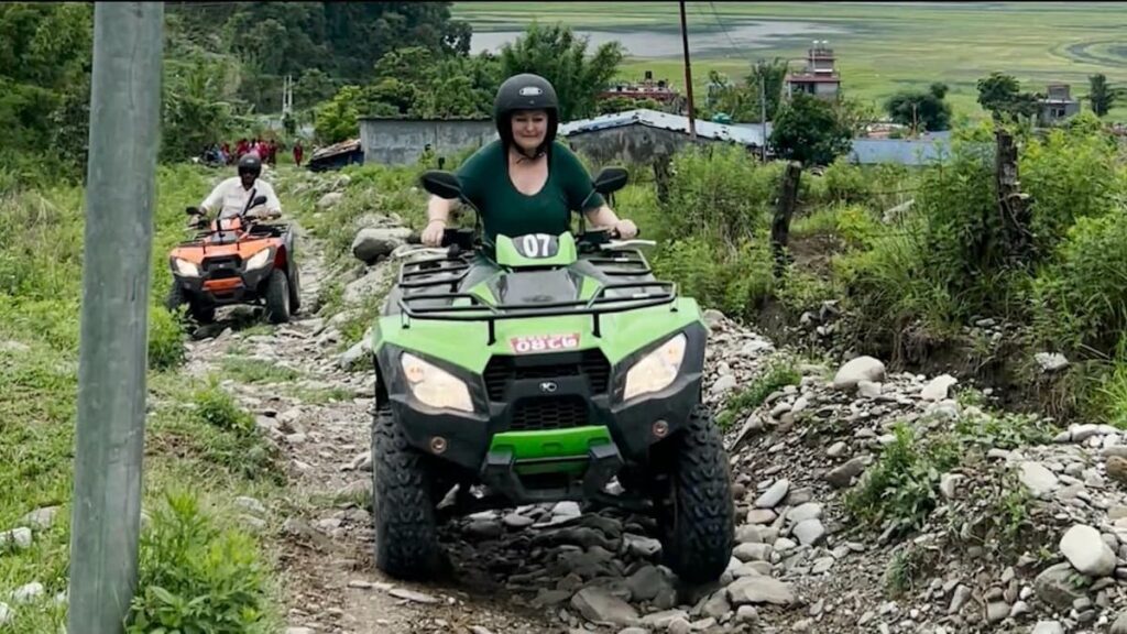 Pokhara adventure activities: rider passing through rice fields